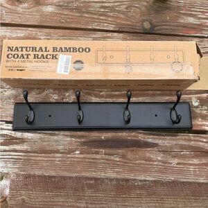 Four hook coat rack in box, never used but screws missing. Dark stain & metal